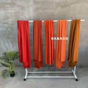 橙色桔红色直贡呢四面弹力，垂顺丝滑布料轻薄透气裙子背景面料