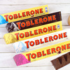 5条瑞士进口零食TOBLERONE三角巴旦木蜂蜜葡萄干牛奶黑巧克力
