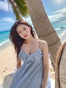 三亚海边旅游度假沙滩长裙女设计感镂空刺绣荷叶边蓝色吊带连衣裙
